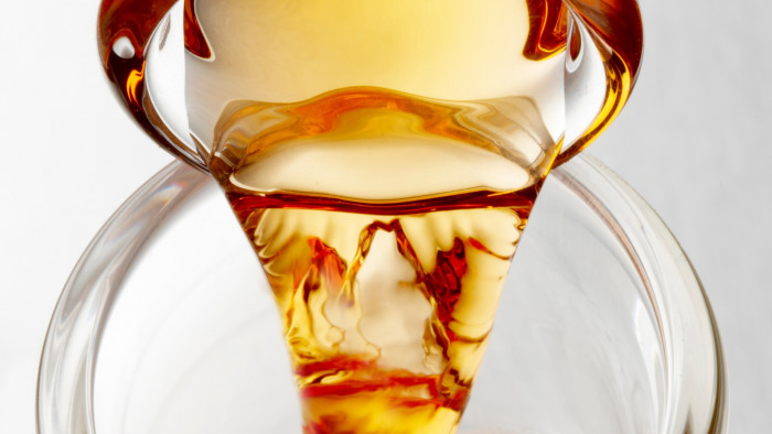 Image of fuel pouring into a glass vessel. Locally produced biofuels are a sustainable alternative for coal.